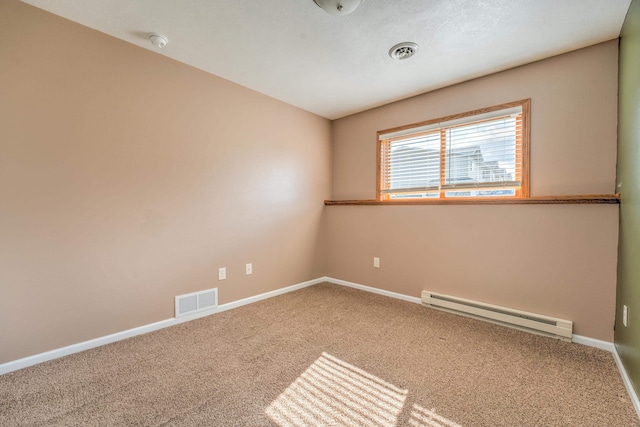 3421 8th St, Minot, ND 58703 - carpeted empty room featuring baseboard heating, a smoke detector, and baseboards