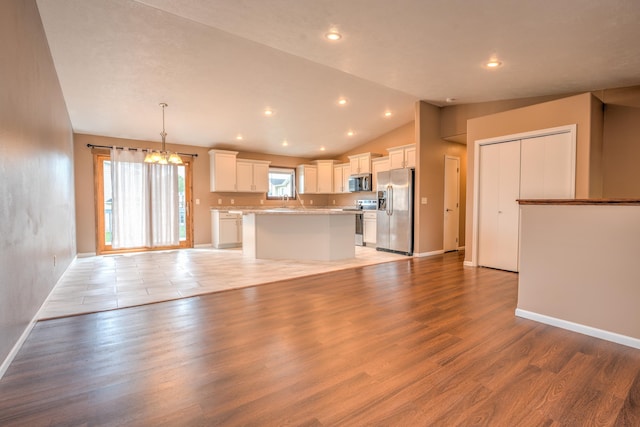 3421 8th St, Minot, ND 58703 - unfurnished living room with a chandelier, light wood-style floors, vaulted ceiling, baseboards, and recessed lighting