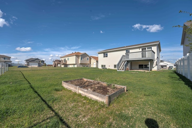 3421 8th St, Minot, ND 58703 - rear view of house with a garden, stairs, and a wooden deck