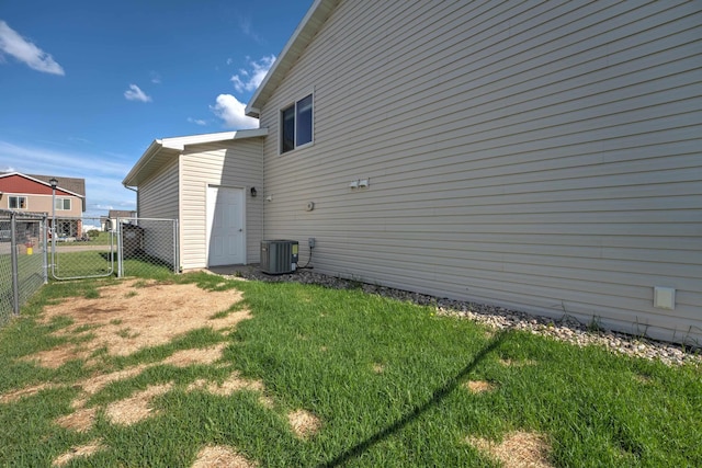 3421 8th St, Minot, ND 58703 - view of side of home featuring central AC unit and a gate