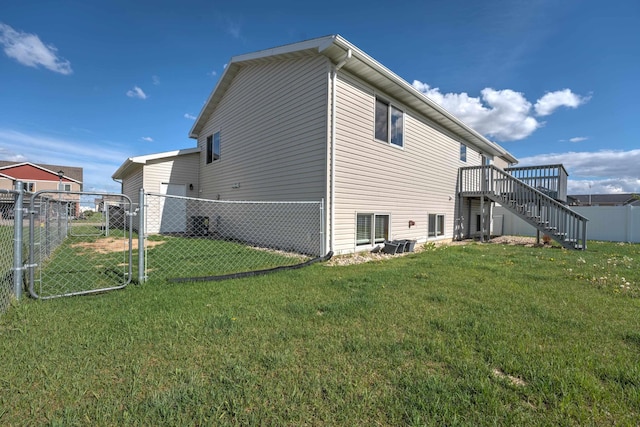 3421 8th St, Minot, ND 58703 - view of side of home featuring stairs, a gate, and a wooden deck
