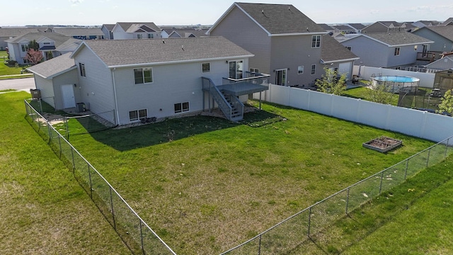 3421 8th St, Minot, ND 58703 - back of house with stairway, a residential view, a wooden deck, and roof with shingles