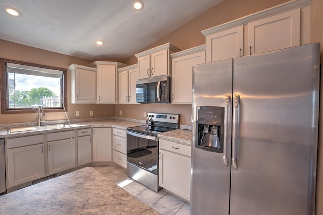 3421 8th St, Minot, ND 58703 - kitchen featuring appliances with stainless steel finishes, a sink, recessed lighting, and white cabinets