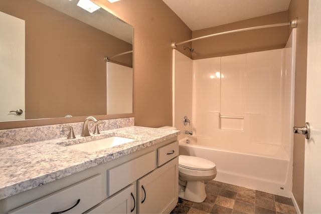3421 8th St, Minot, ND 58703 - full bathroom featuring vanity, toilet, bathing tub / shower combination, and stone finish flooring