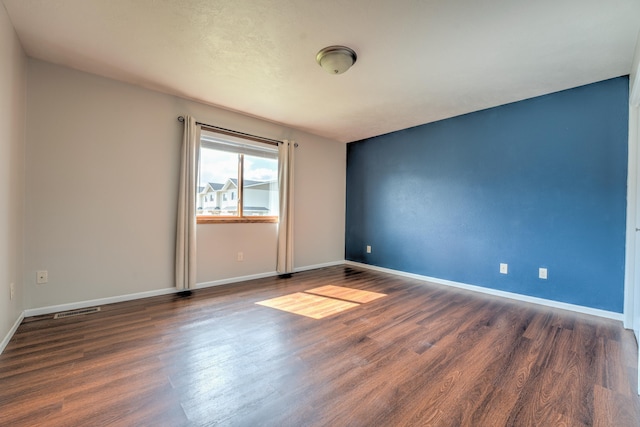 3421 8th St, Minot, ND 58703 - empty room with wood finished floors and baseboards