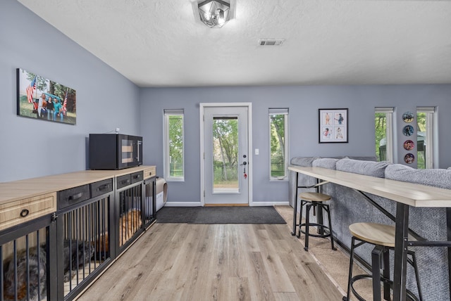1321 Golden Valley Ln, Minot, ND 58703 - living room with wood finished floors, baseboards, and a textured ceiling