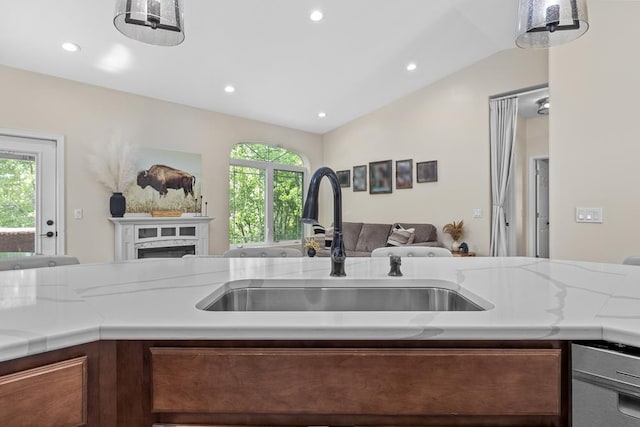 1321 Golden Valley Ln, Minot, ND 58703 - kitchen featuring open floor plan, a sink, light countertops, vaulted ceiling, and stainless steel dishwasher