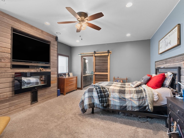 6125 11th Ave, Minot, ND 58701 - carpeted bedroom featuring a glass covered fireplace, recessed lighting, a ceiling fan, and a barn door