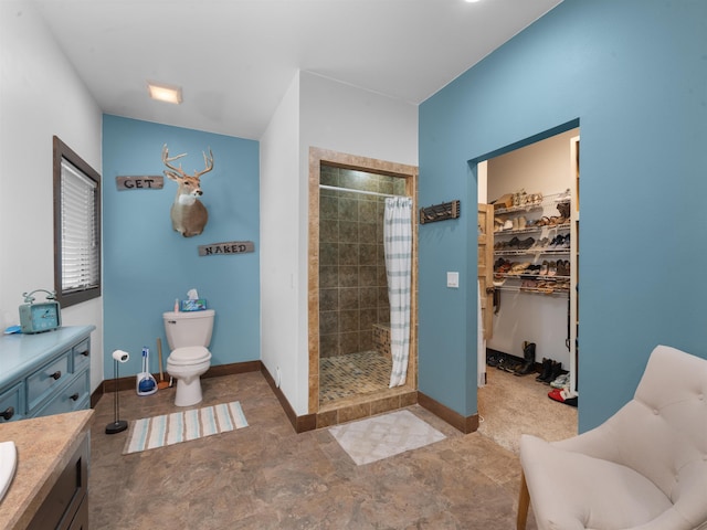 6125 11th Ave, Minot, ND 58701 - full bathroom with a shower stall, toilet, vanity, and baseboards
