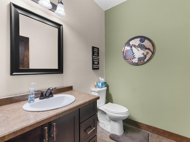 6125 11th Ave, Minot, ND 58701 - bathroom with vanity, toilet, tile patterned floors, and baseboards