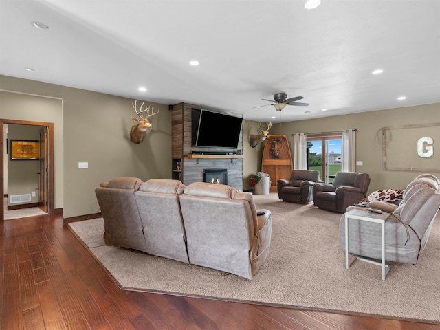 6125 11th Ave, Minot, ND 58701 - living room featuring a large fireplace, a ceiling fan, recessed lighting, dark wood finished floors, and baseboards