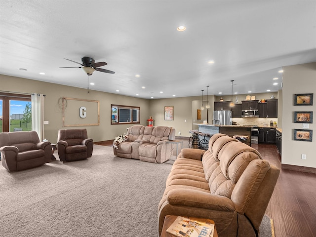 6125 11th Ave, Minot, ND 58701 - living room featuring recessed lighting, ceiling fan, baseboards, and dark wood-style flooring
