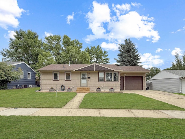 424 26th St, Minot, ND 58703 - single story home with an attached garage, concrete driveway, and a front yard