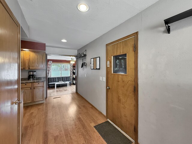 424 26th St, Minot, ND 58703 - hall with light wood finished floors and recessed lighting