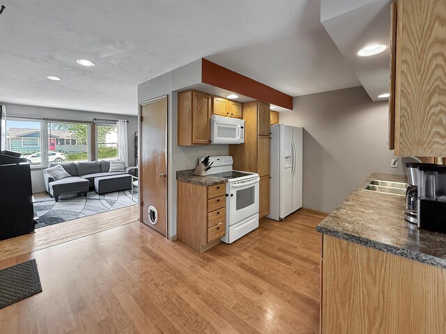 424 26th St, Minot, ND 58703 - kitchen with white appliances, a sink, open floor plan, light wood finished floors, and recessed lighting