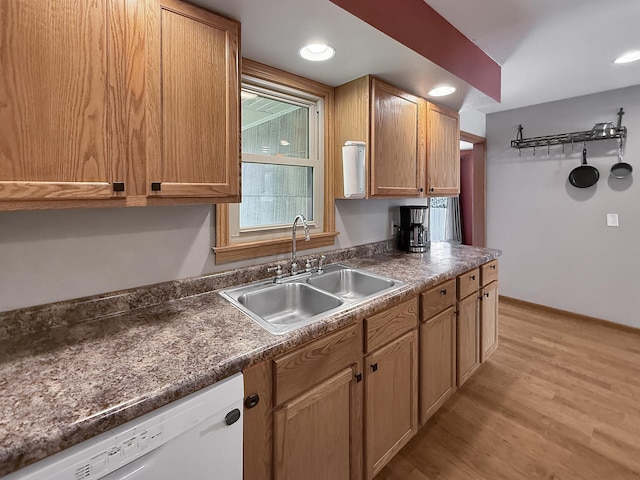 424 26th St, Minot, ND 58703 - kitchen featuring white dishwasher, a sink, light wood-style floors, dark countertops, and recessed lighting