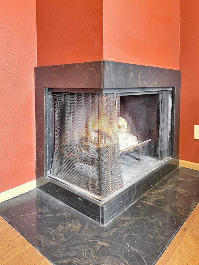 424 26th St, Minot, ND 58703 - detailed view of a fireplace, baseboards, and a textured wall