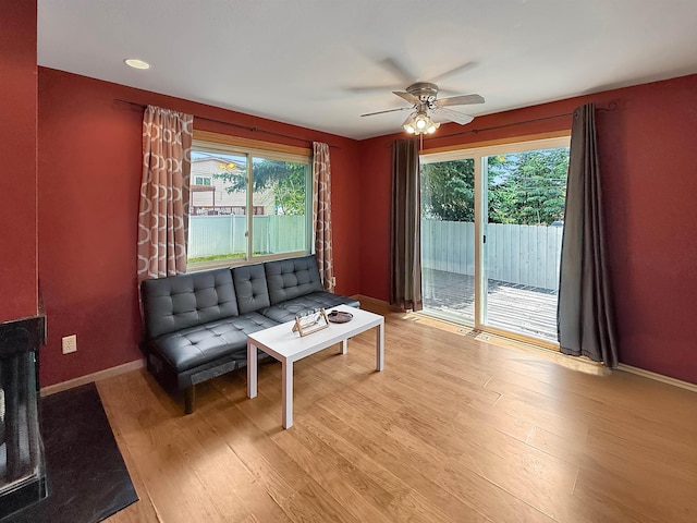 424 26th St, Minot, ND 58703 - living area featuring healthy amount of natural light, a ceiling fan, wood finished floors, and baseboards