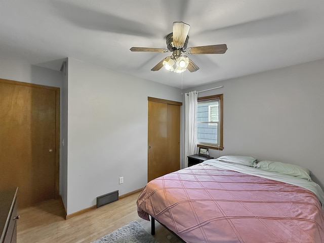 424 26th St, Minot, ND 58703 - bedroom featuring light wood-style flooring, a closet, ceiling fan, and baseboards