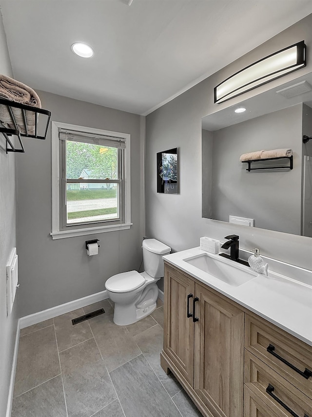 424 26th St, Minot, ND 58703 - bathroom featuring toilet, vanity, baseboards, tile patterned flooring, and recessed lighting