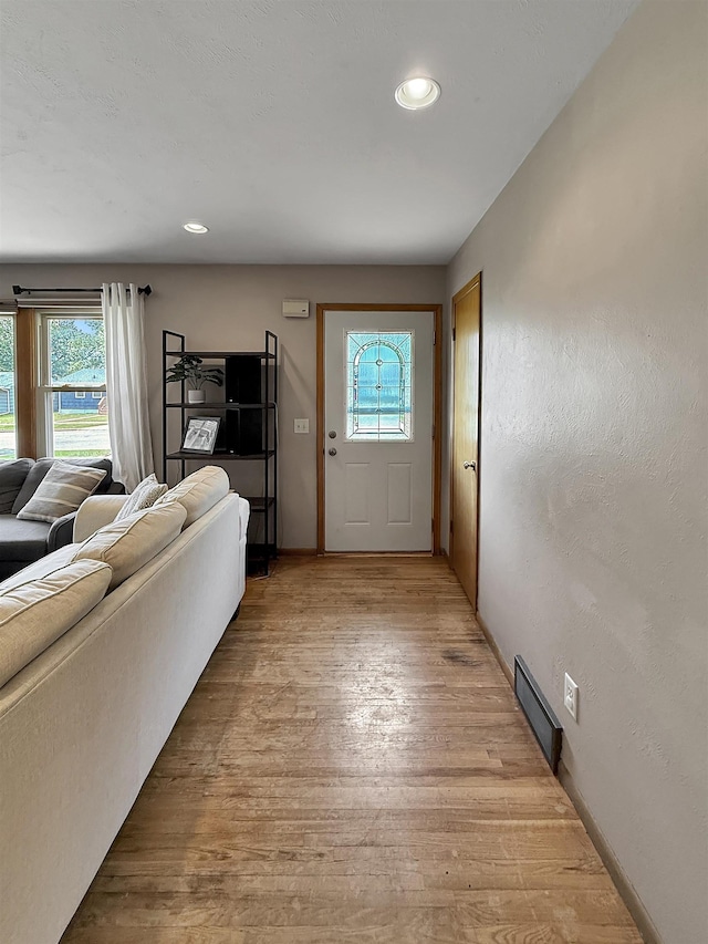 424 26th St, Minot, ND 58703 - foyer entrance featuring healthy amount of natural light, light wood-type flooring, recessed lighting, and baseboards