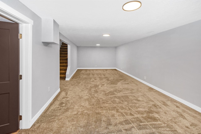 1821 11th St, Minot, ND 58701 - finished basement featuring carpet, baseboards, recessed lighting, and stairway