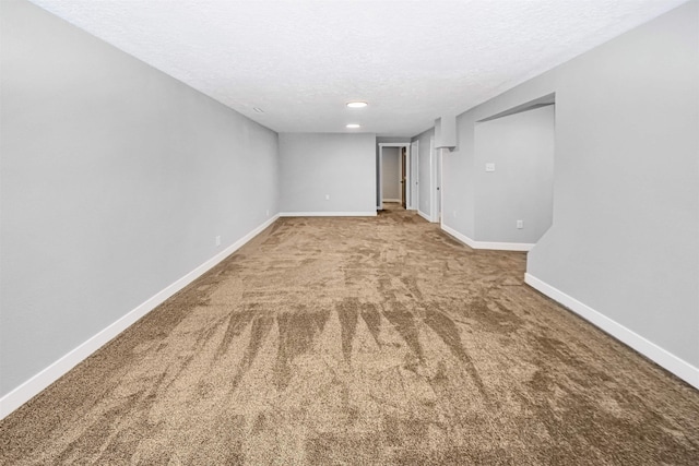 1821 11th St, Minot, ND 58701 - carpeted spare room with a textured ceiling, baseboards, and recessed lighting