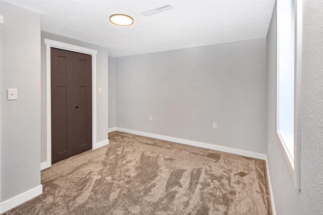 1821 11th St, Minot, ND 58701 - spare room with carpet floors and baseboards