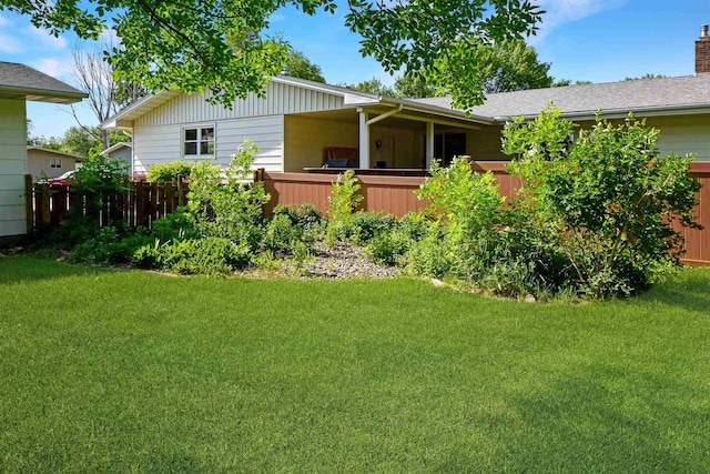 1821 11th St, Minot, ND 58701 - rear view of house featuring a lawn and a chimney