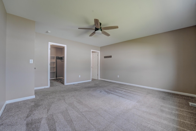 3328 NW 20th Ave, Minot, ND 58703 - unfurnished bedroom with carpet, a walk in closet, baseboards, and a closet