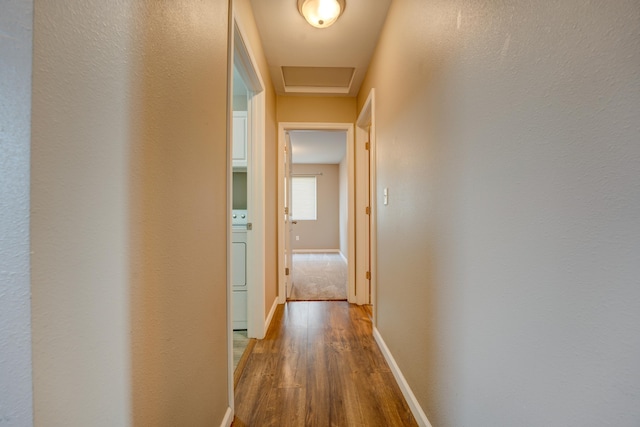 3328 NW 20th Ave, Minot, ND 58703 - hall with wood finished floors, baseboards, and washer / clothes dryer