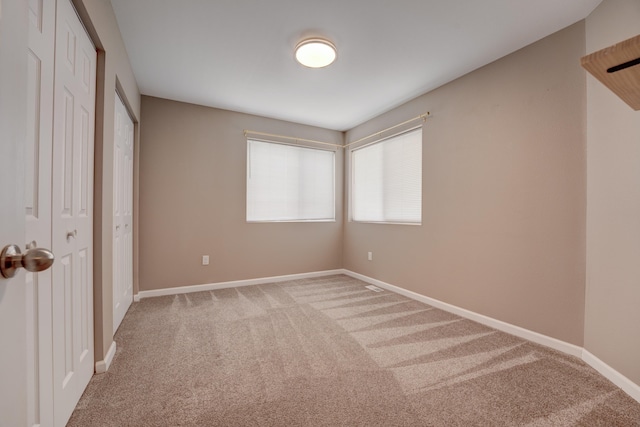 3328 NW 20th Ave, Minot, ND 58703 - unfurnished bedroom featuring carpet and baseboards