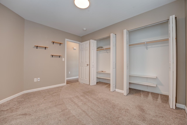 3328 NW 20th Ave, Minot, ND 58703 - unfurnished bedroom with multiple closets, carpet floors, and baseboards