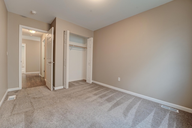 3328 NW 20th Ave, Minot, ND 58703 - unfurnished bedroom featuring carpet, baseboards, and a closet
