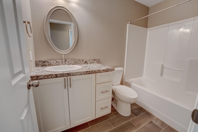 3328 NW 20th Ave, Minot, ND 58703 - full bath featuring vanity, toilet, bathtub / shower combination, and wood finish floors