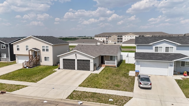 3328 NW 20th Ave, Minot, ND 58703 - traditional-style home featuring driveway, a residential view, and a garage