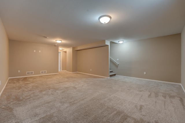 3328 NW 20th Ave, Minot, ND 58703 - unfurnished room featuring light carpet, stairs, and baseboards