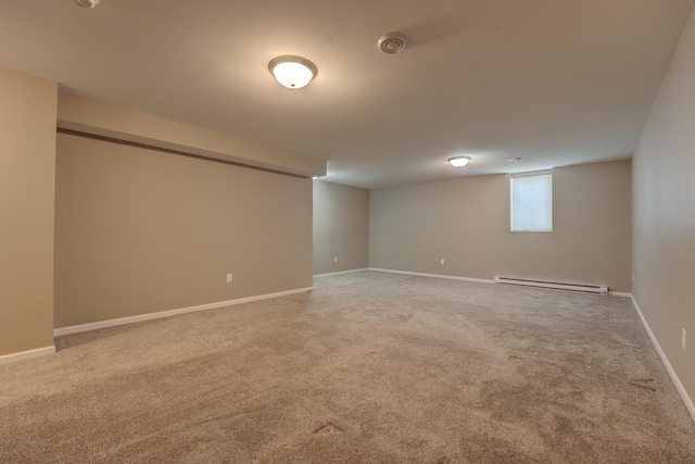 3328 NW 20th Ave, Minot, ND 58703 - basement featuring a baseboard radiator, carpet floors, and baseboards