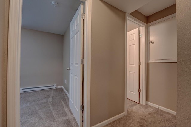 3328 NW 20th Ave, Minot, ND 58703 - corridor featuring a baseboard radiator, carpet floors, and baseboards