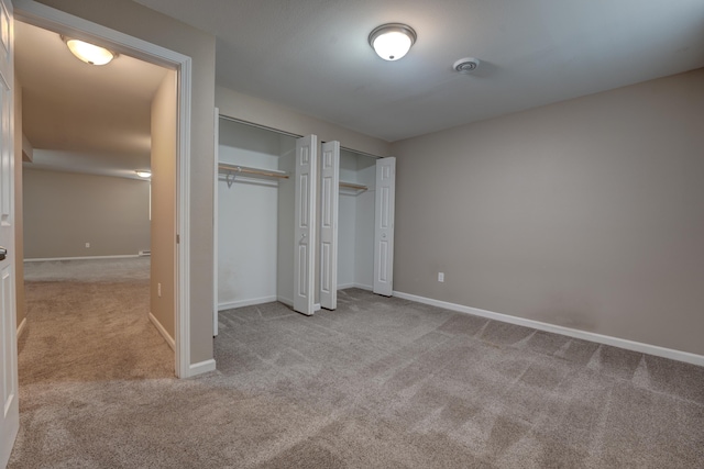 3328 NW 20th Ave, Minot, ND 58703 - unfurnished bedroom featuring two closets, carpet floors, and baseboards