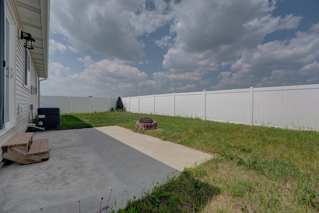 3328 NW 20th Ave, Minot, ND 58703 - view of yard with central air condition unit, a patio area, and an outdoor fire pit