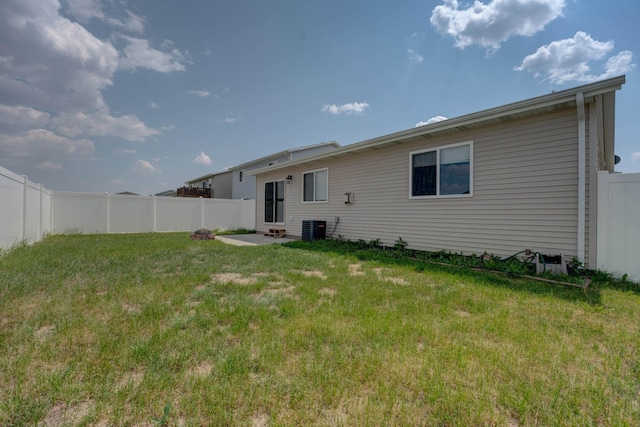 3328 NW 20th Ave, Minot, ND 58703 - rear view of property featuring central AC unit and entry steps