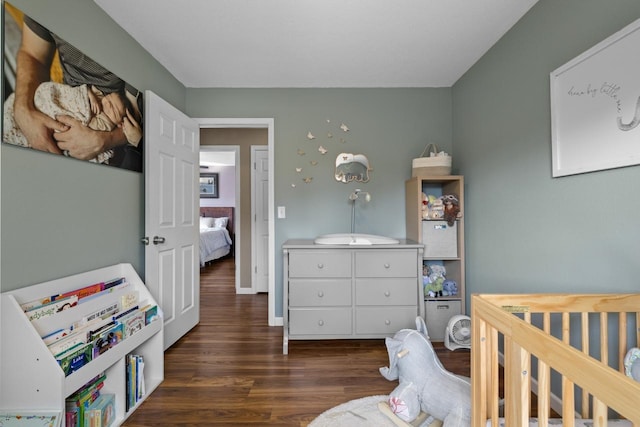 1925 10th St, Minot, ND 58703 - bedroom with dark wood-style flooring