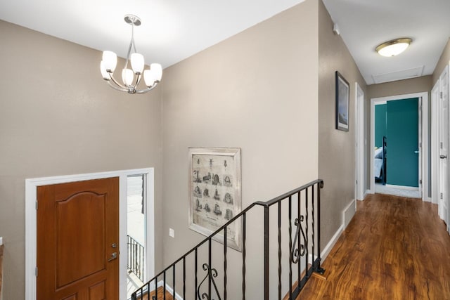 1925 10th St, Minot, ND 58703 - foyer entrance featuring dark wood-style floors, a chandelier, and baseboards