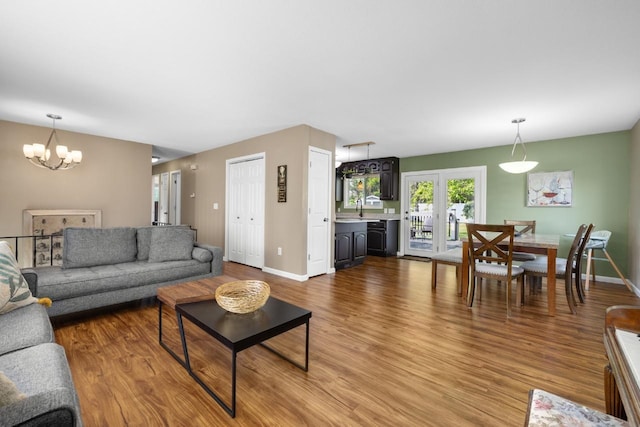 1925 10th St, Minot, ND 58703 - living room with a chandelier, wood finished floors, and baseboards
