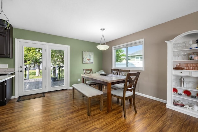1925 10th St, Minot, ND 58703 - dining room featuring dark wood-style floors and baseboards