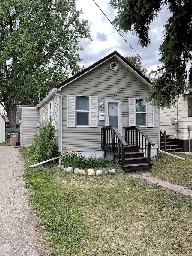 525 12th St, Minot, ND 58703 - view of front of house with a front lawn