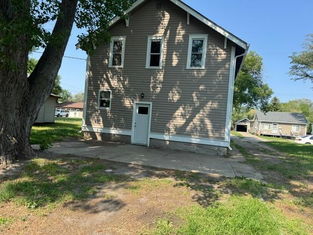616 10th St, Minot, ND 58703 - back of house featuring a patio area