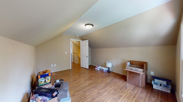 917 4th Ave, Minot, ND 58703 - rec room with wood finished floors, lofted ceiling, and baseboards