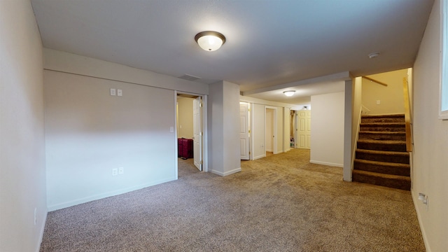917 4th Ave, Minot, ND 58703 - carpeted spare room with stairs, baseboards, and a smoke detector